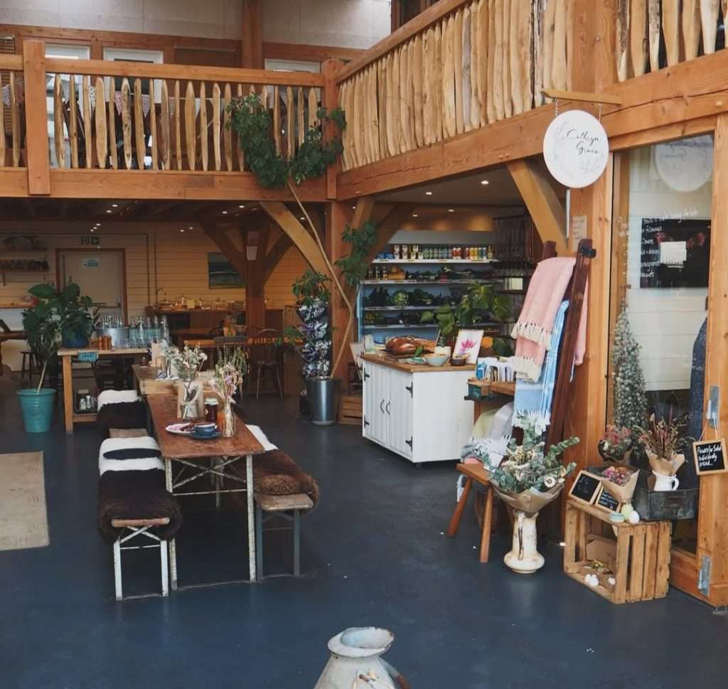 Timber-framed shop interior with a counter and displays at Village Farm